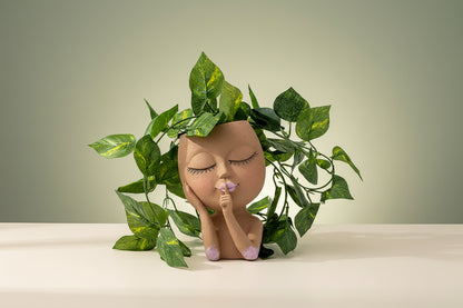 Decorative figurine with plant on a gradient wall