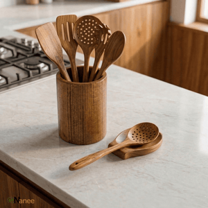Wooden kitchen utensils in a holder on a kitchen counter