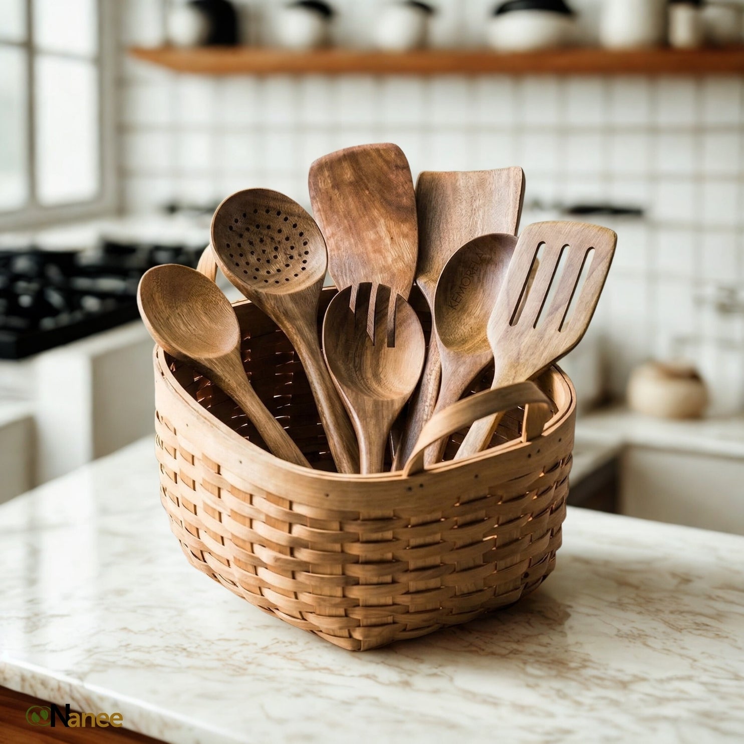 Premium Teak Wood utensils in a woven basket on a marble countertop with a blurred kitchen background.