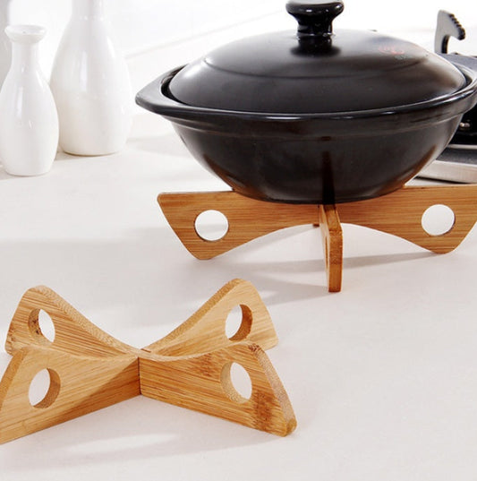 Black pot on a wooden stand with a white background