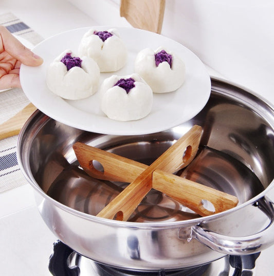 Stainless steel pot with wooden sticks on a white background